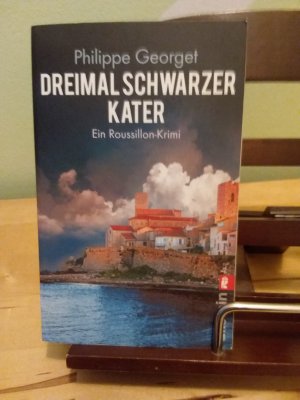 gebrauchtes Buch – Philippe Georget – Dreimal schwarzer Kater - ein Roussillon-Krimi