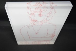 Portrait von André Heller (1981)., Lithographie in Rot unter Plexiglas-Platte (21 x 16,5 x 2 cm.).